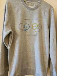 Grey graphic crewneck sweatshirt on a hanger, showing glasses-face line art with blue and yellow accents