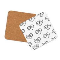 White square coaster with repeating black smiling glasses pattern, rounded corners and brown backing shown behind it