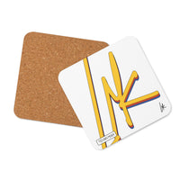 White square coaster with bold yellow graphic artwork and red and blue outlines, shown with brown backing