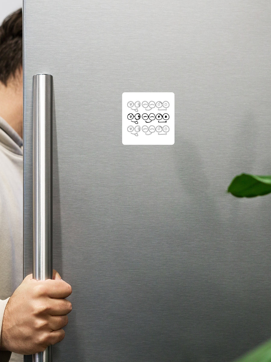 White square fridge magnet with nine glasses-face illustrations in black and gray on a stainless steel refrigerator