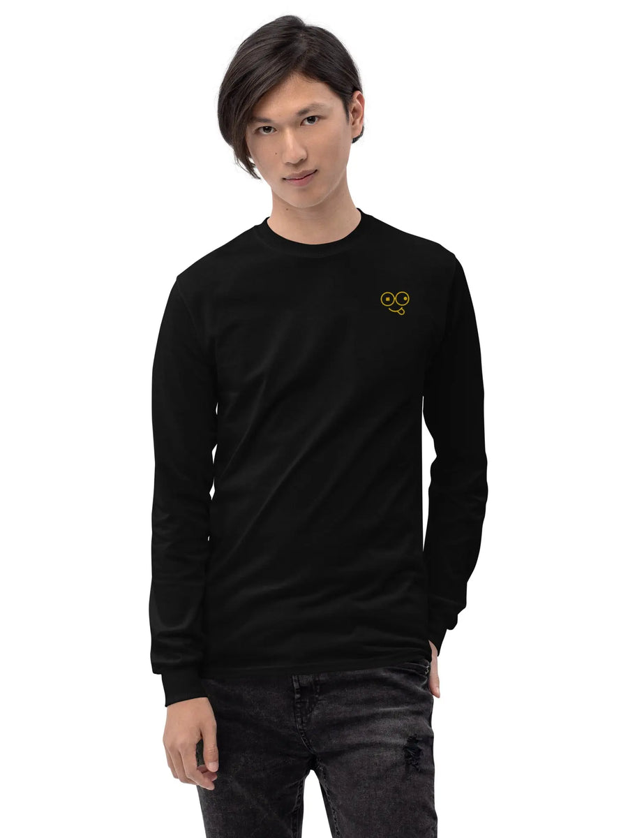 Model wearing a black long sleeve t-shirt with ribbed cuffs and a yellow glasses-face chest design
