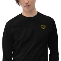 Close-up of a black crew neck t-shirt showing the yellow tongue-out glasses-face chest design