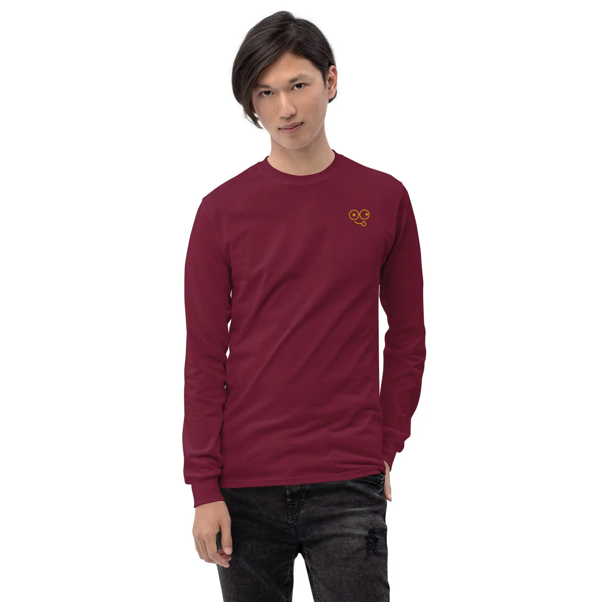 Model wearing a maroon long sleeve t-shirt with ribbed cuffs and a yellow glasses-face chest design