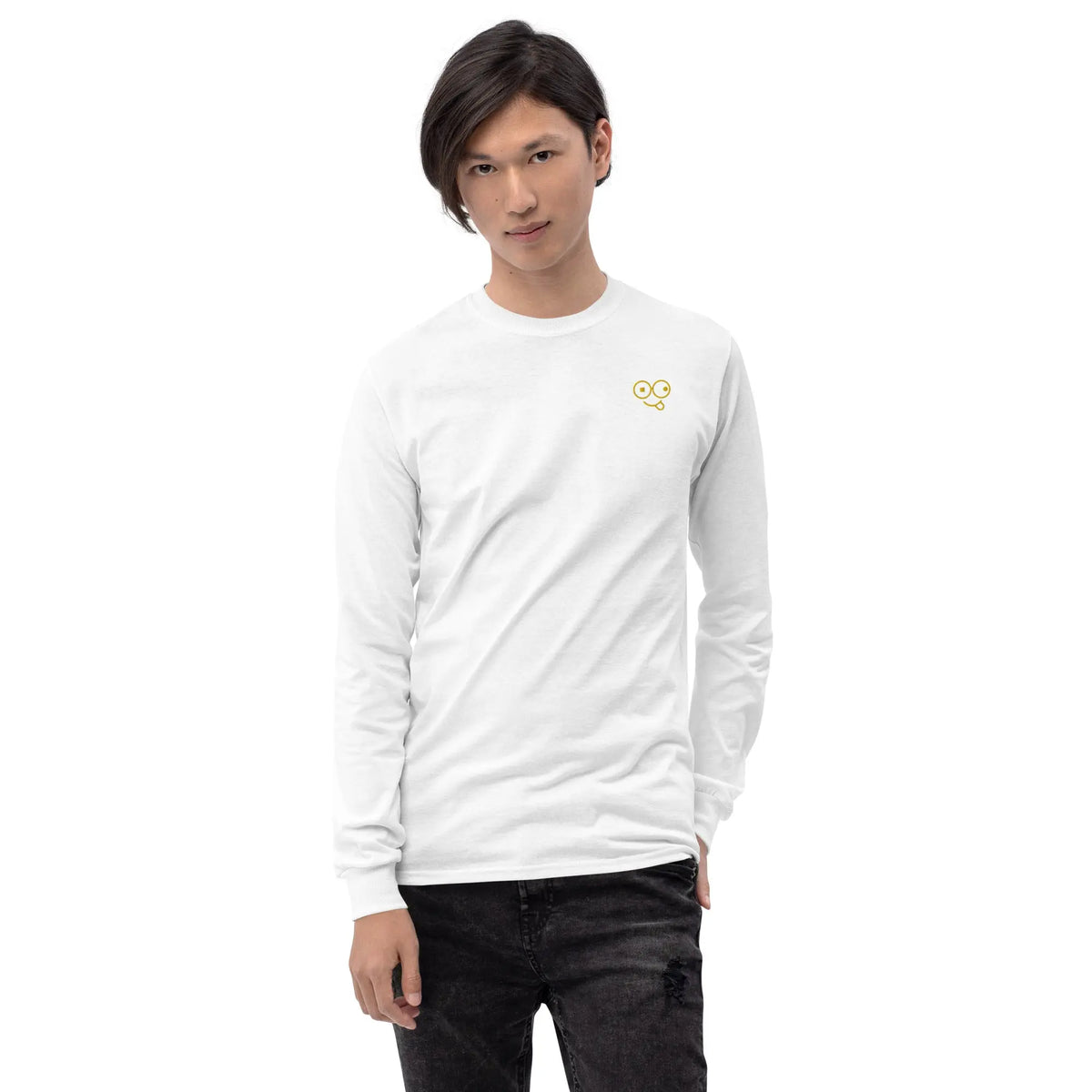 Model wearing a white long sleeve crew neck t-shirt with a small yellow glasses-face chest design