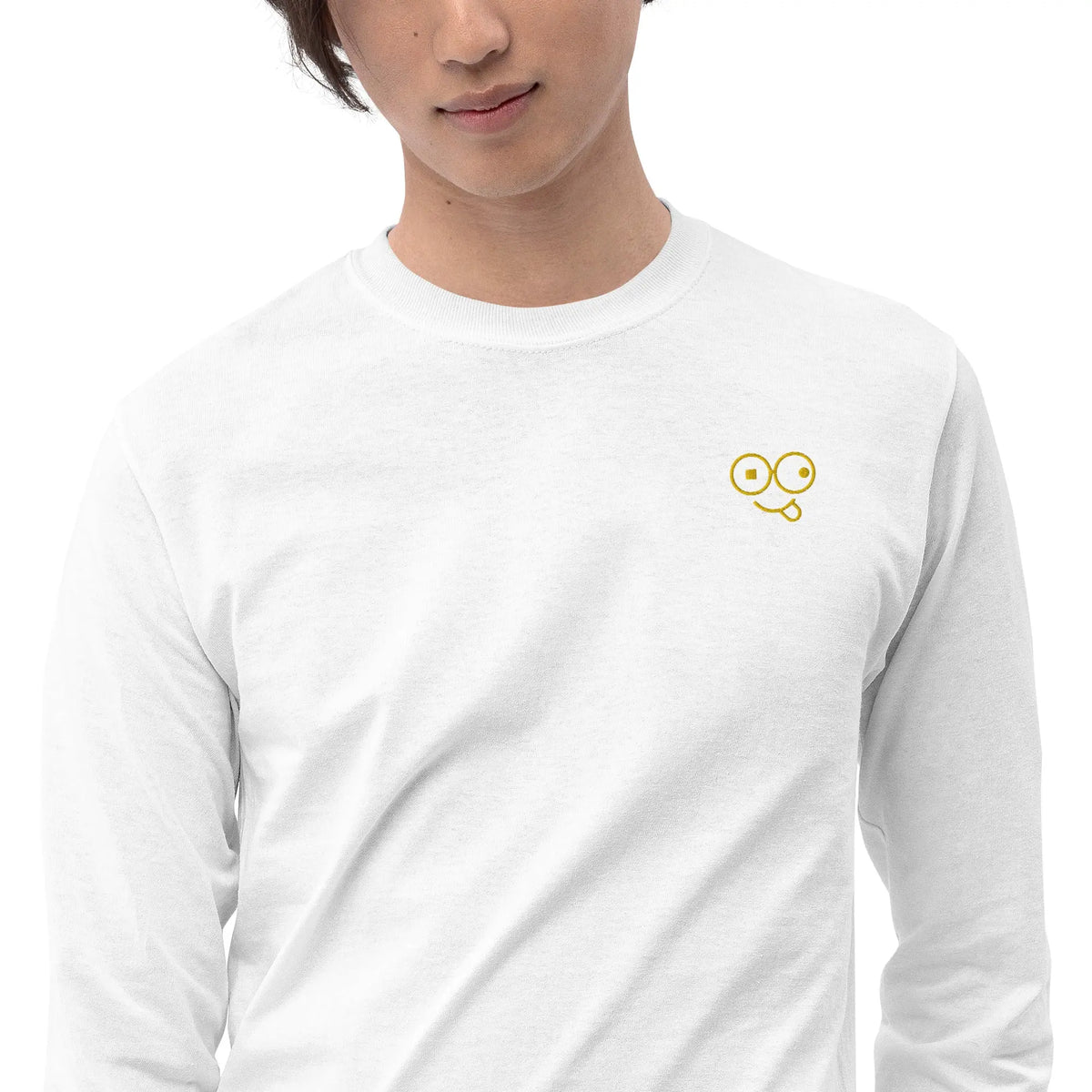 Close-up of a white crew neck t-shirt showing the yellow tongue-out glasses-face chest design