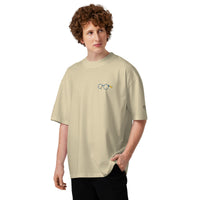 Model wearing a stone oversized t-shirt with dropped shoulders and a small glasses chest graphic