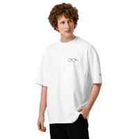 Model wearing a white oversized t-shirt with dropped shoulders and a small glasses chest graphic