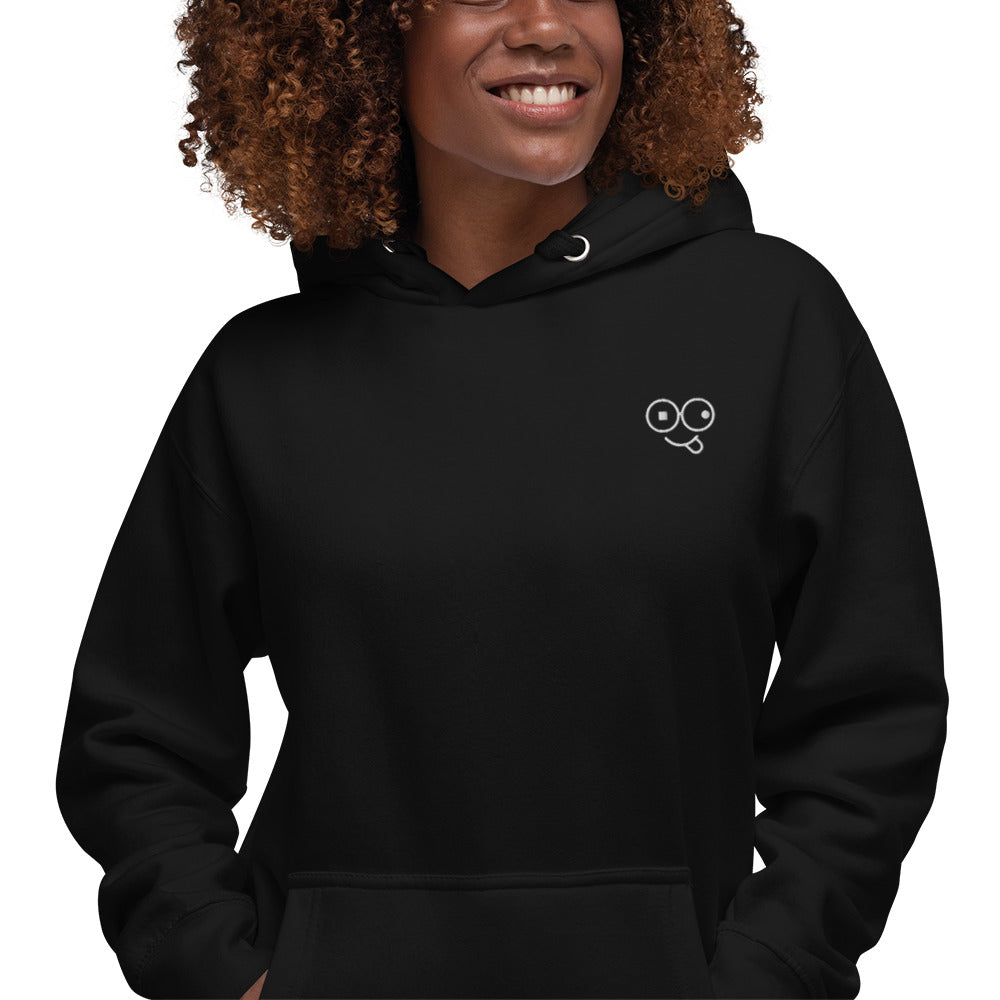 Close-up of a black hoodie showing the white tongue-out glasses-face chest design