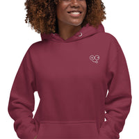 Close-up of a maroon hoodie showing the white tongue-out glasses-face chest design