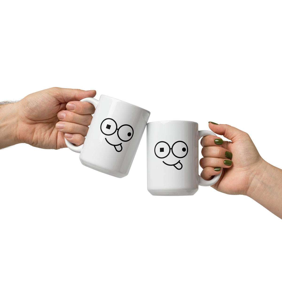Pair of white mugs with black glasses-face artwork and tongue-out smiles, held by their handles against a white background